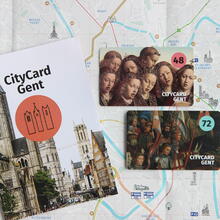 City map of Ghent folded open with on top the city guide and city cards (48 + 72)